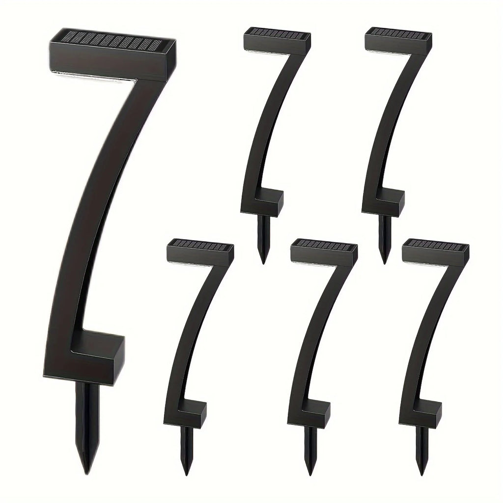 Set of black metal house numbers on a white background