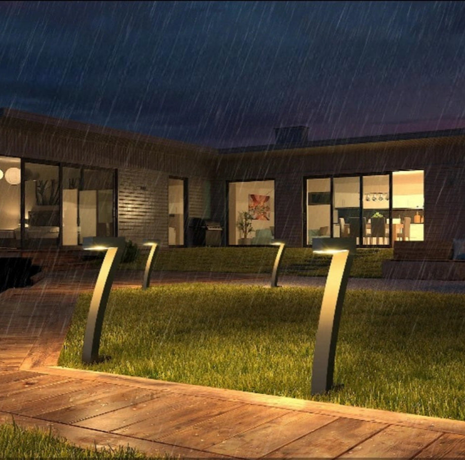 Modern outdoor patio with lighting fixtures during rain.
